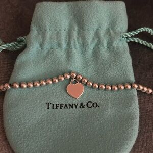 Tiffany & Co. silver mini ball bracelet with mini pink heart.
